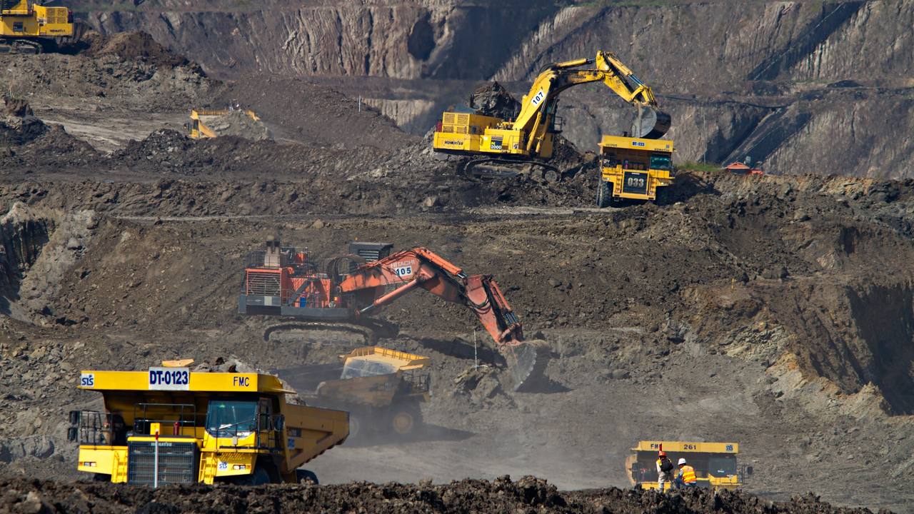 Excavators loading haul trucks on a mine bench