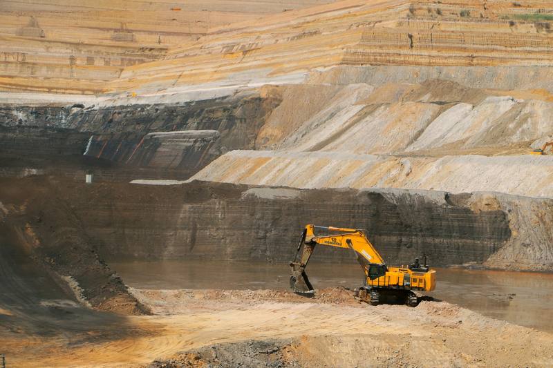 Excavator working on the floor of an open-pit mine